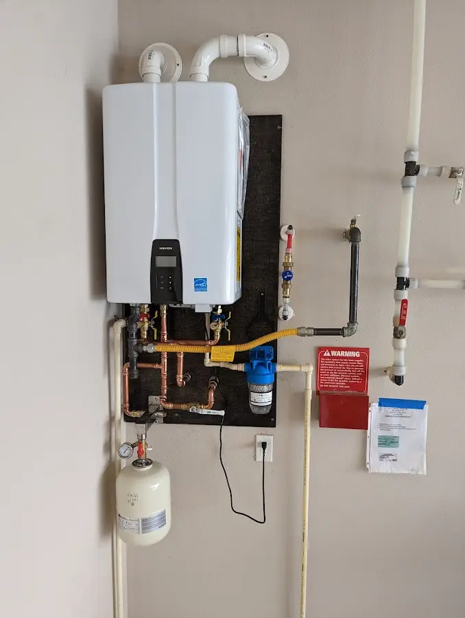 Professional plumber installing copper piping in a Pohatcong home